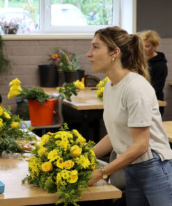 Student working on dropshape funeral arrangement