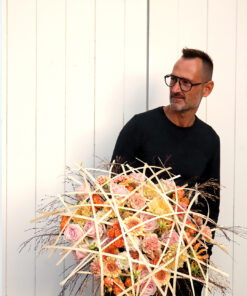Alex Segura holding a Handtied Frame Bouquet